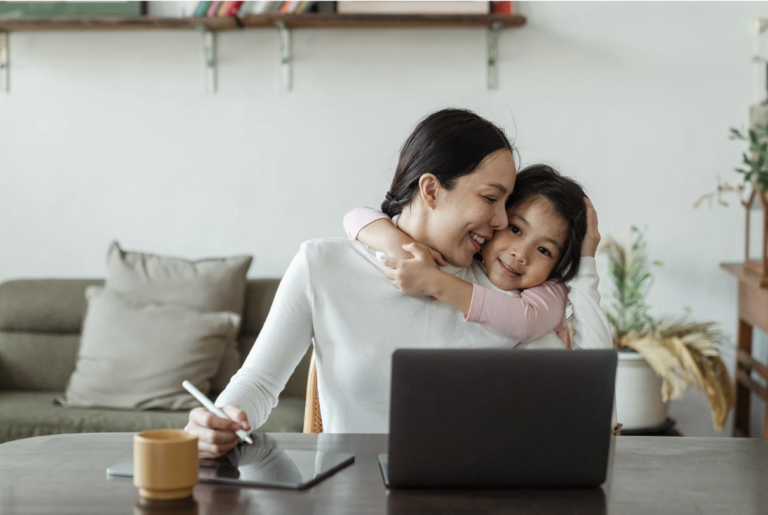 A woman and her child in front of a computer, symbolising the balance between family law, work commitments, and personal life, guided by family lawyers near Maitland and Newcastle.