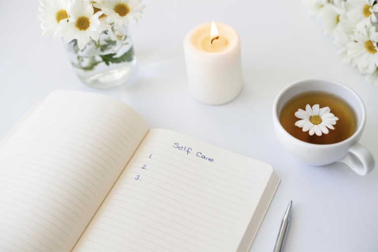 A self-care journal open on a table, symbolising the importance of self-care and reflection after a divorce with the support of experienced family lawyers.