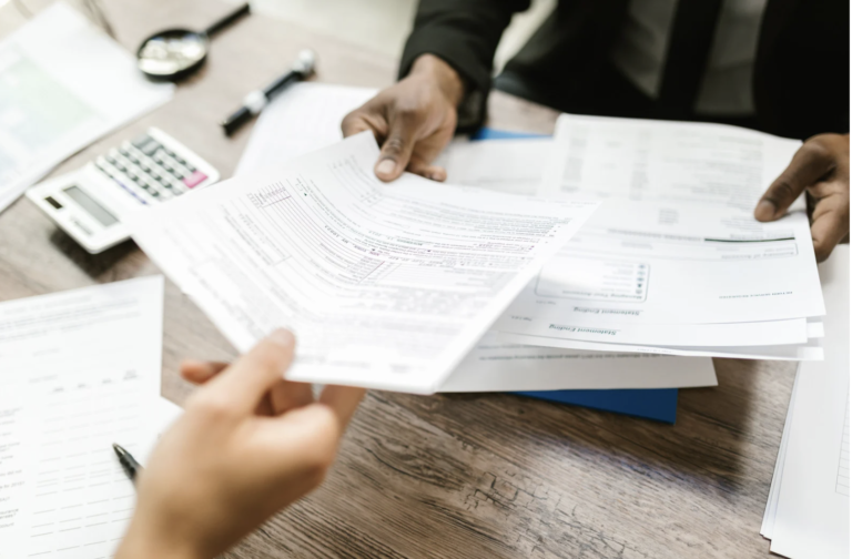 People organising documents, representing the preparation and organisation needed for a family law case with the help of family lawyers.