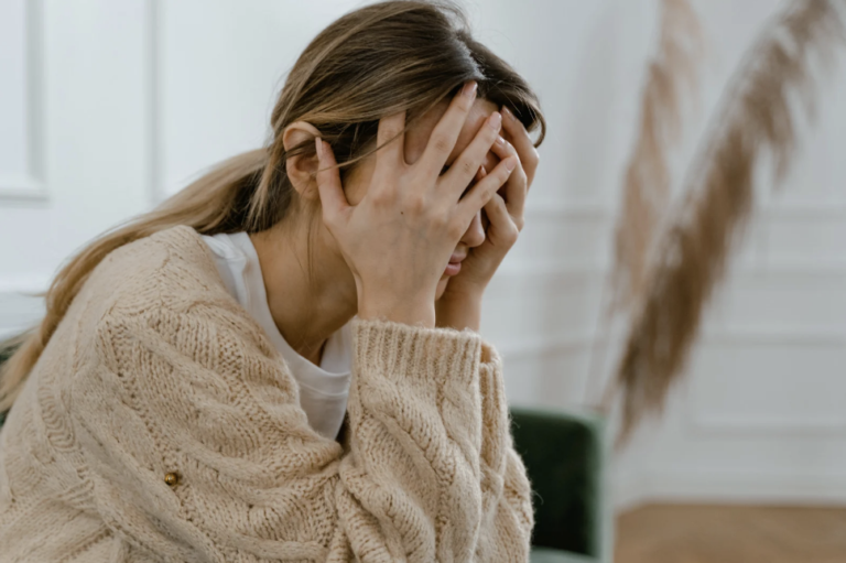 A frustrated and scared woman experiencing the emotional and financial impact of coercive control and domestic violence in relationships.