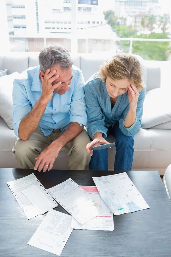 Separating couple arguing over a piggy bank during discussions about property settlement and superannuation
